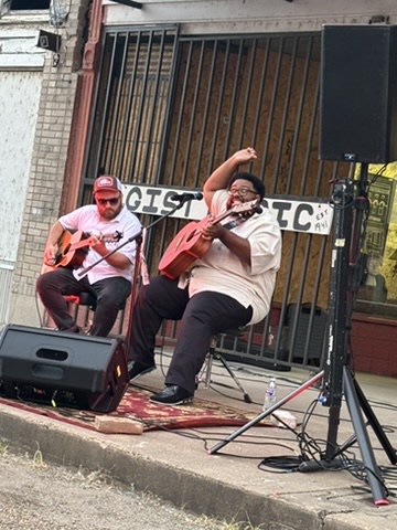 Live acoustic performance outside the Gist Music storefront on Cherry Street, Helena, Arkansas