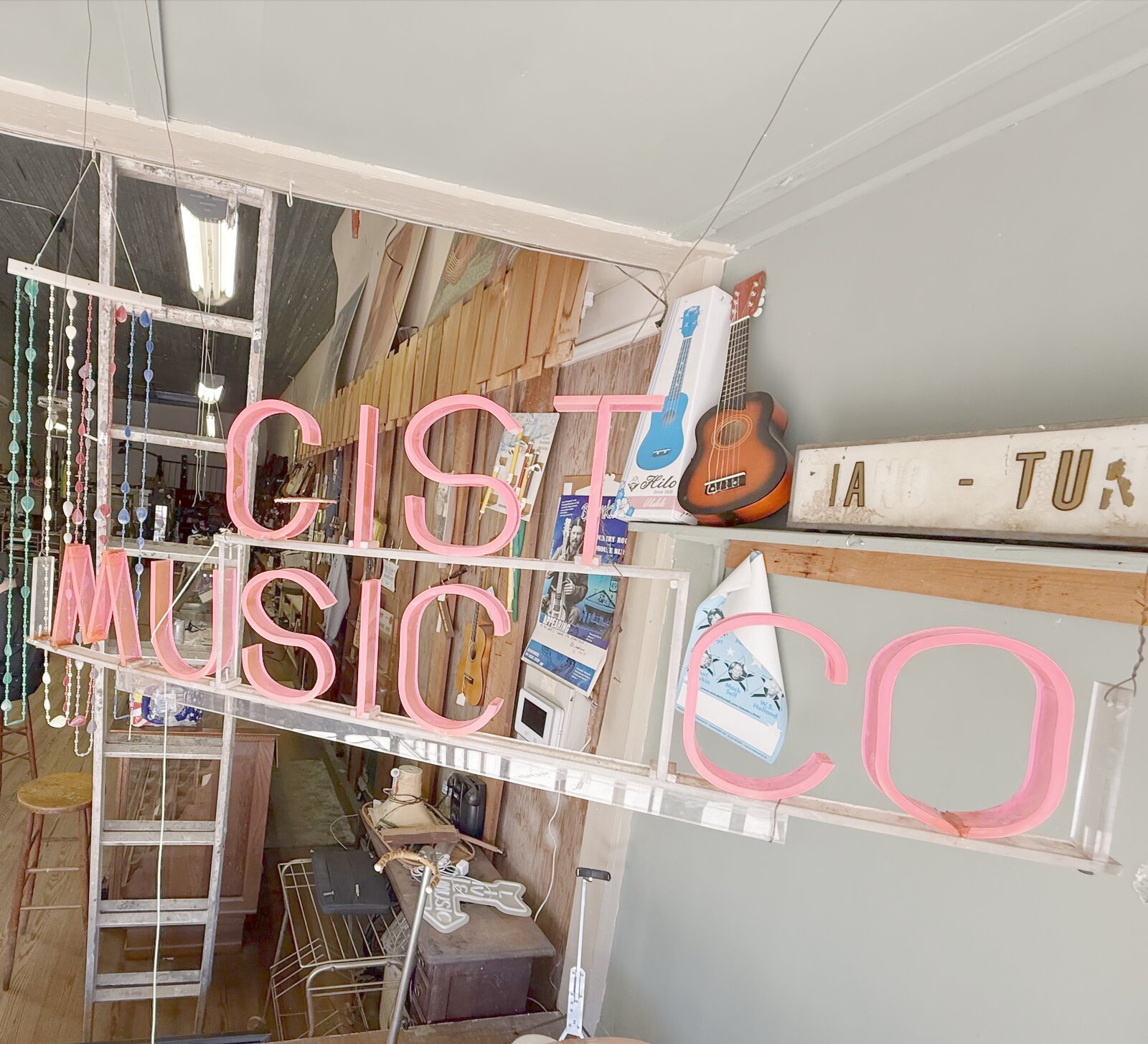 The Gist Music Co. neon sign inside the store